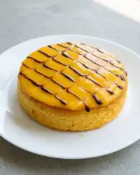 Pureeing fresh golden alphonso mangoes to make a Mango Fresh Fruit Topped Cake batter.