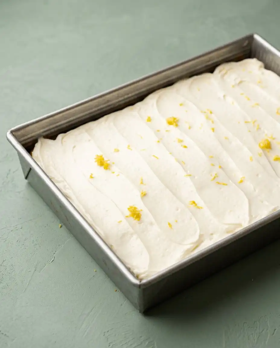Zucchini Cake with Lemon Cream Cheese Frosting 16 A fully decorated zucchini cake with lemon cream cheese frosting garnished with fresh lemon zest.