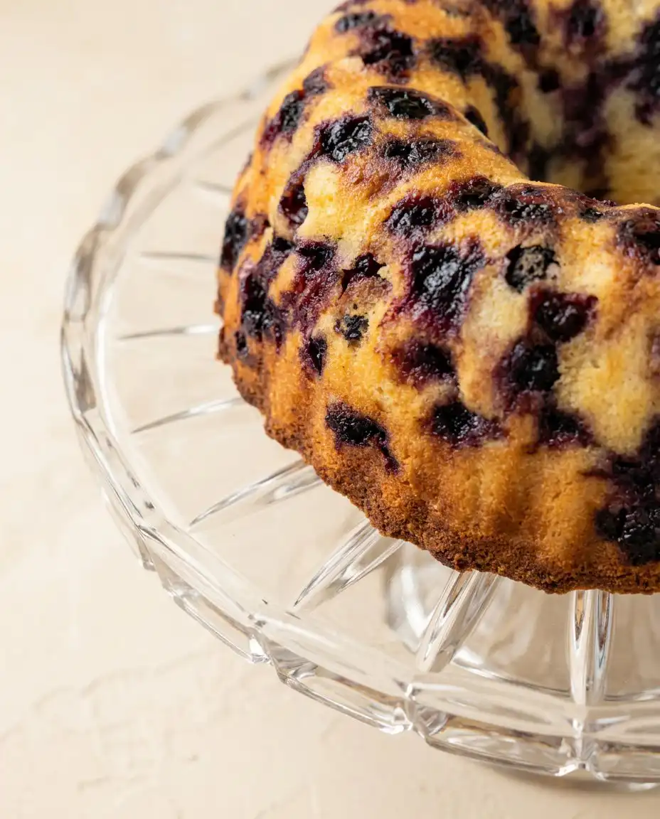 Lemon Blueberry Bundt Cake with Lemon Glaze 16 A slice of Lemon Blueberry Bundt Cake with Lemon Glaze served with fresh cream.
