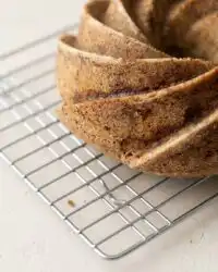 Slices of warm spiced pear cake arranged on a rustic wooden board