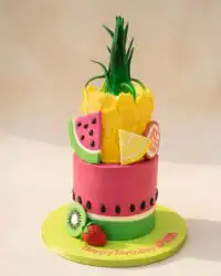 A stacked Watermelon and Pineapple Tropical Fruit Cake decorated with berries